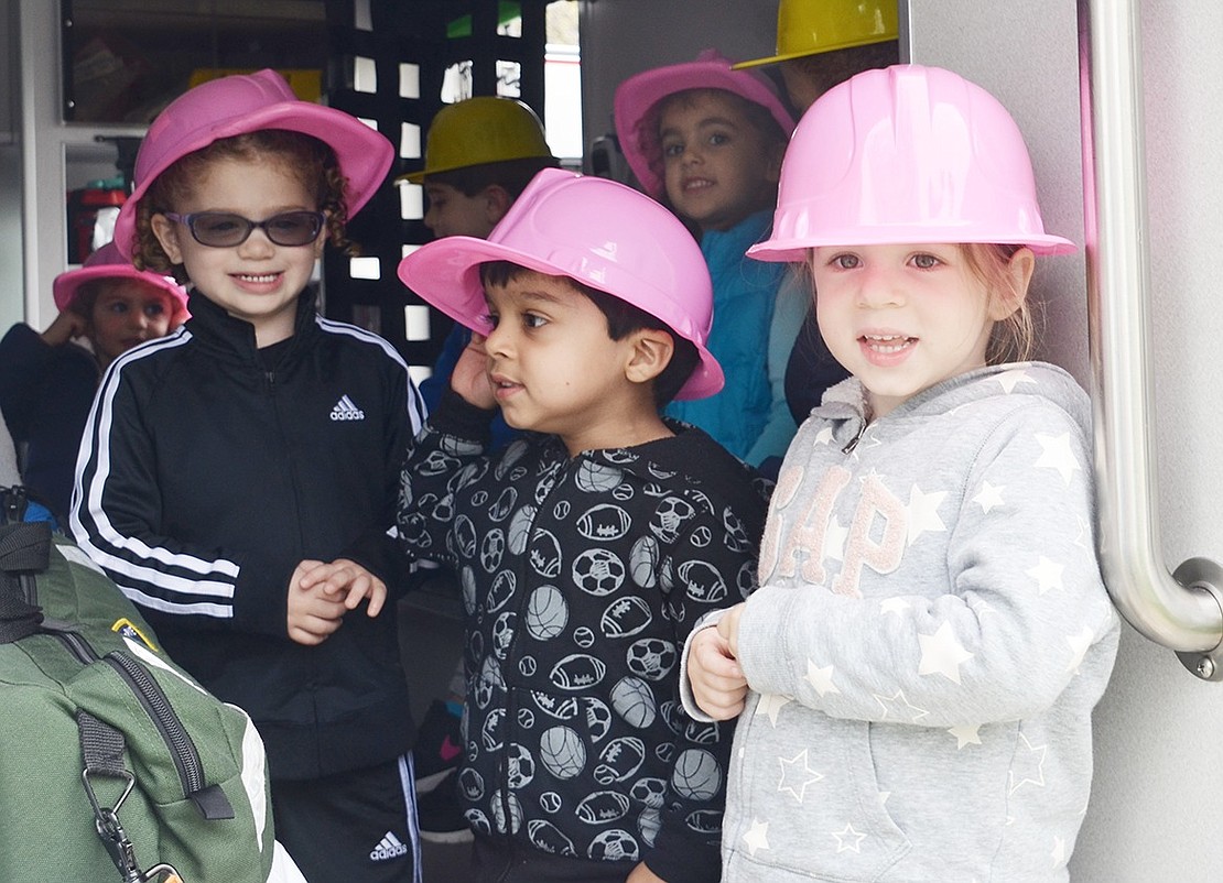 Three-year-olds Dylan Stroud, Ronin Dhar, Emily Rosen (in back) and Izabella Lang tour an ambulance operated by the Port Chester-Rye-Rye Brook EMS.