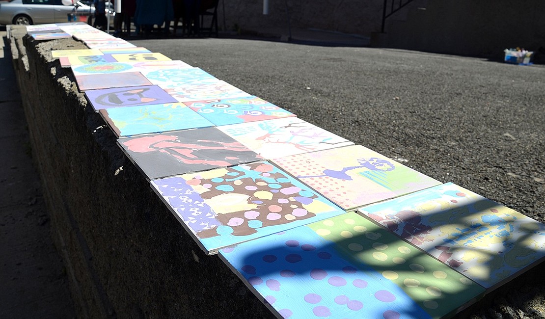 The tiles made by children are laid out to dry in the sun.