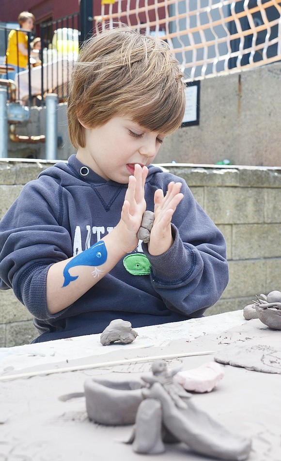 Clay sculptures litter the table and 5-year-old Lucas Lazlo of Greenwich, Conn., contributes to covering the surface with a fake spaghetti dinner. 