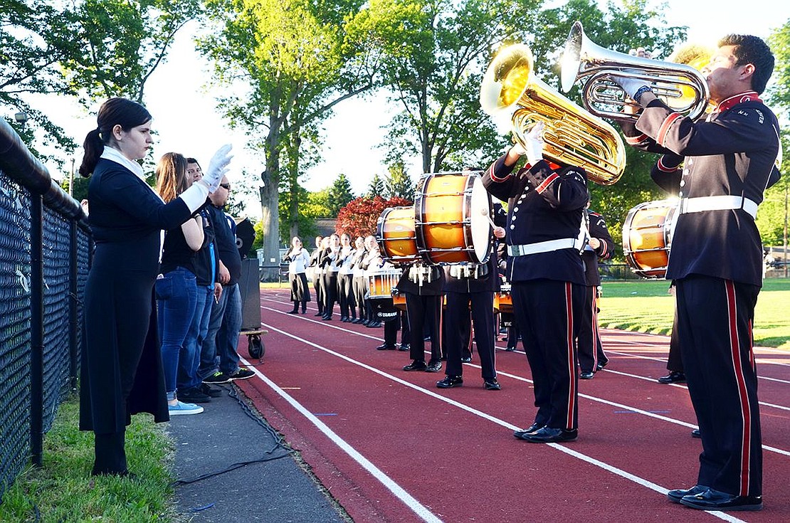 Senior drum major Elizabeth Montemurro conducts the Port Chester High School Marching Band which entertains the crowd before the elementary school bands take over the football field. 