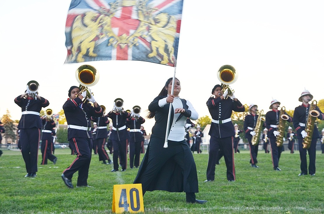 The Port Chester High School Marching Band performs its last “Tommy” routine as the sun begins to set behind the high school. 