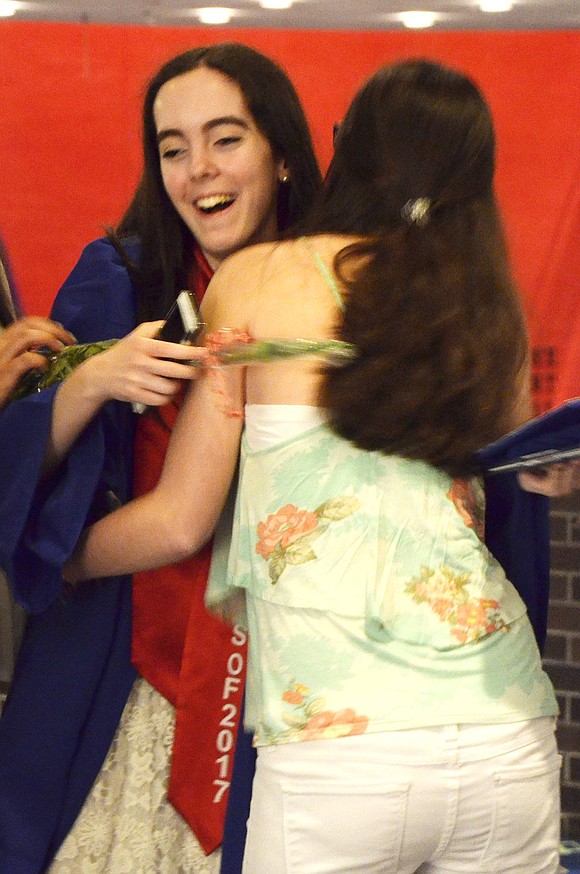 Graduate Lauren Rothmann is congratulated with a hug from friend Danielle Barsky. 