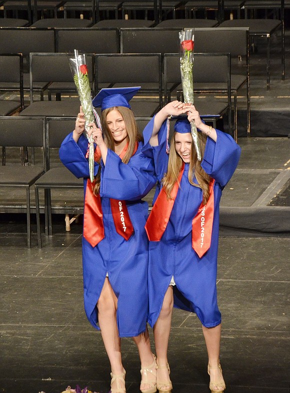 Emily Wexler and Erica Wels hip bump one another in excitement.   