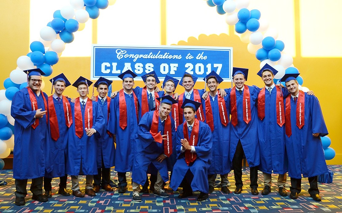 Congratulations, boys! A group of graduates pose under the balloon archway. 