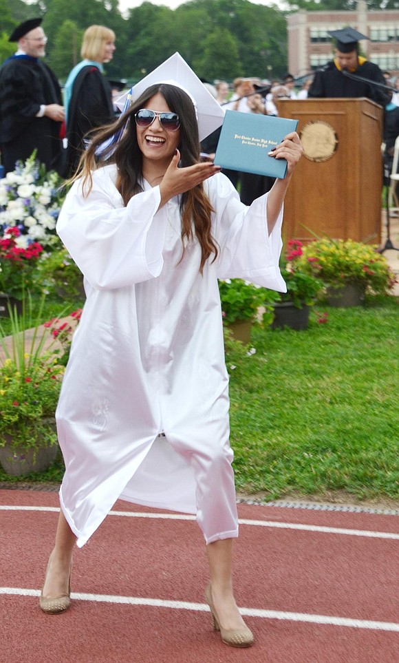 Port Chester High School graduate Beatriz Rivera shows off the diploma she just picked up from school board member Carolee Brakewood at the school’s 133rd commencement on Friday, June 23 at Ryan Stadium.  