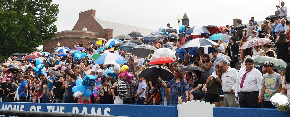 Many audience members break out umbrellas to keep them dry when the skies open up.