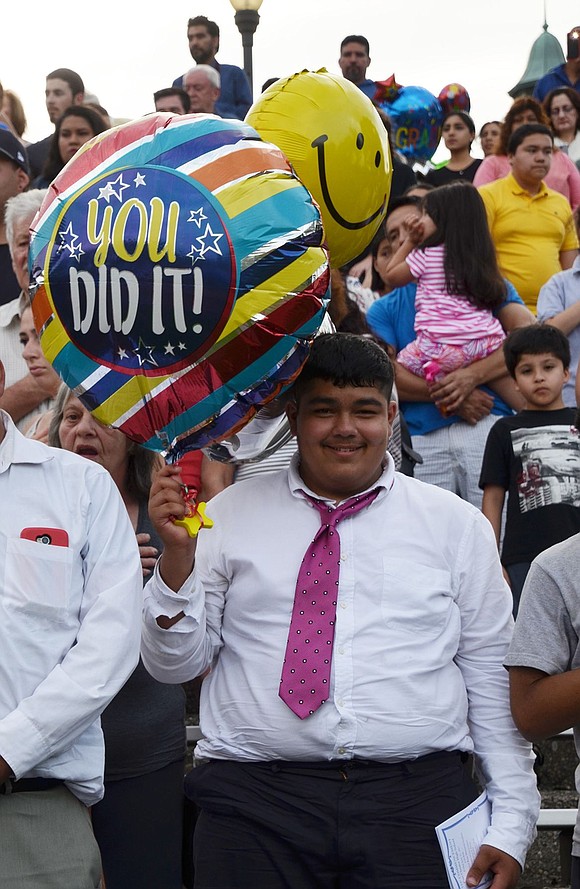 “You Did It!” reads this balloon carried by a loved one in the audience.