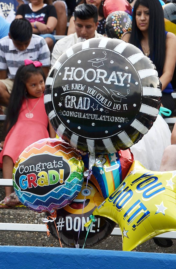 Some of the many congratulatory balloons carried by family and friends in the stands.