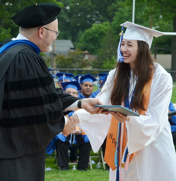 Valedictorian Emily Loiaconi receives her diploma from Principal Dr. Mitchell Combs.