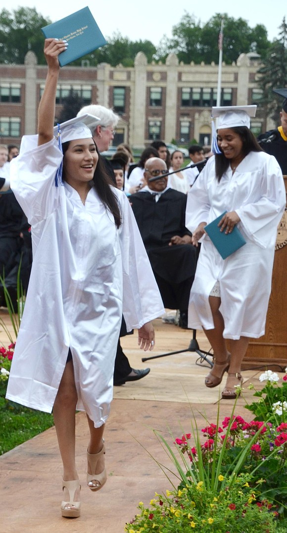 Iris Huyhua holds up her diploma for all to see.