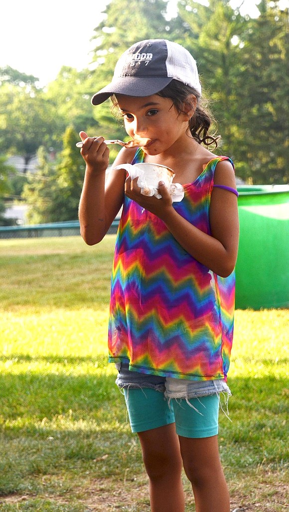 Six-year-old Valencia Loor-Steinberg of Brookside Way was quick to scarf down her frozen treat.  