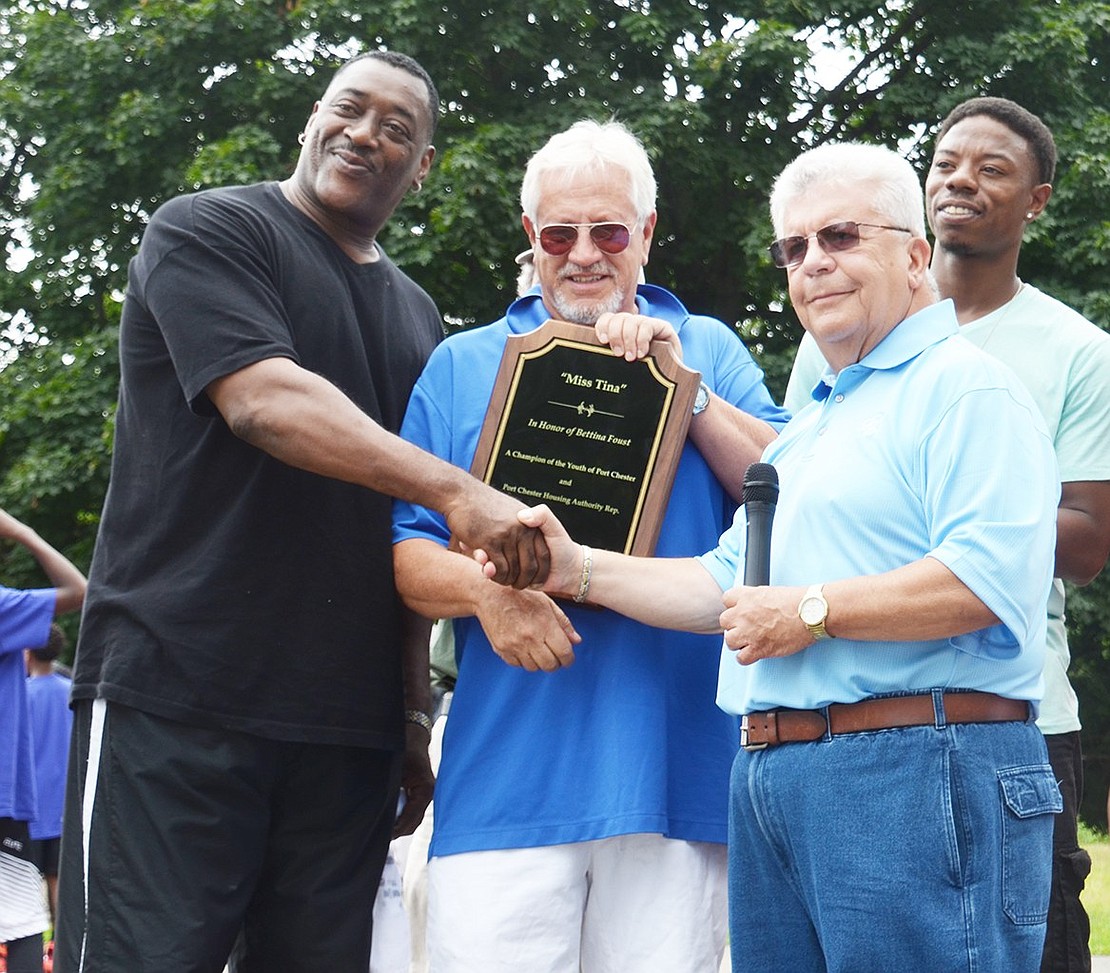 To honor Bettina Foust, who died July 26, 2013, the Corbia and Larizza families purchased a plaque, which will be turned over to the Port Chester Housing Authority and placed inside the apartment building at 45 Traverse Ave. where she lived. To accept the memorial from Tom Corbia (middle) was her son, Alfie Foust. Mayor Richard “Fritz” Falanka is at right. The tablet reads, “‘Miss Tina,’ In Honor of Bettina Foust. A Champion of the Youth of Port Chester and Port Chester Housing Authority Representative. Thank You.”