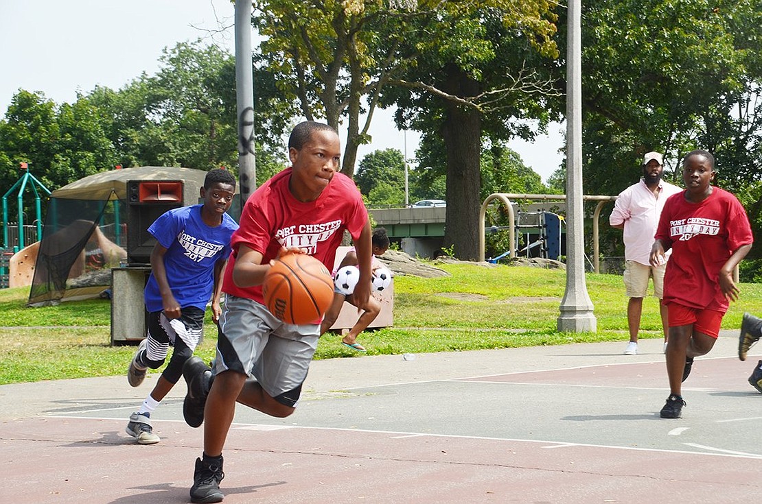 Thirteen-year-old C.J. Harris of Port Chester shows off his dribbling skills as he dominates the Columbus Park basketball court during Port Chester Unity Day on Saturday, Aug. 12. 