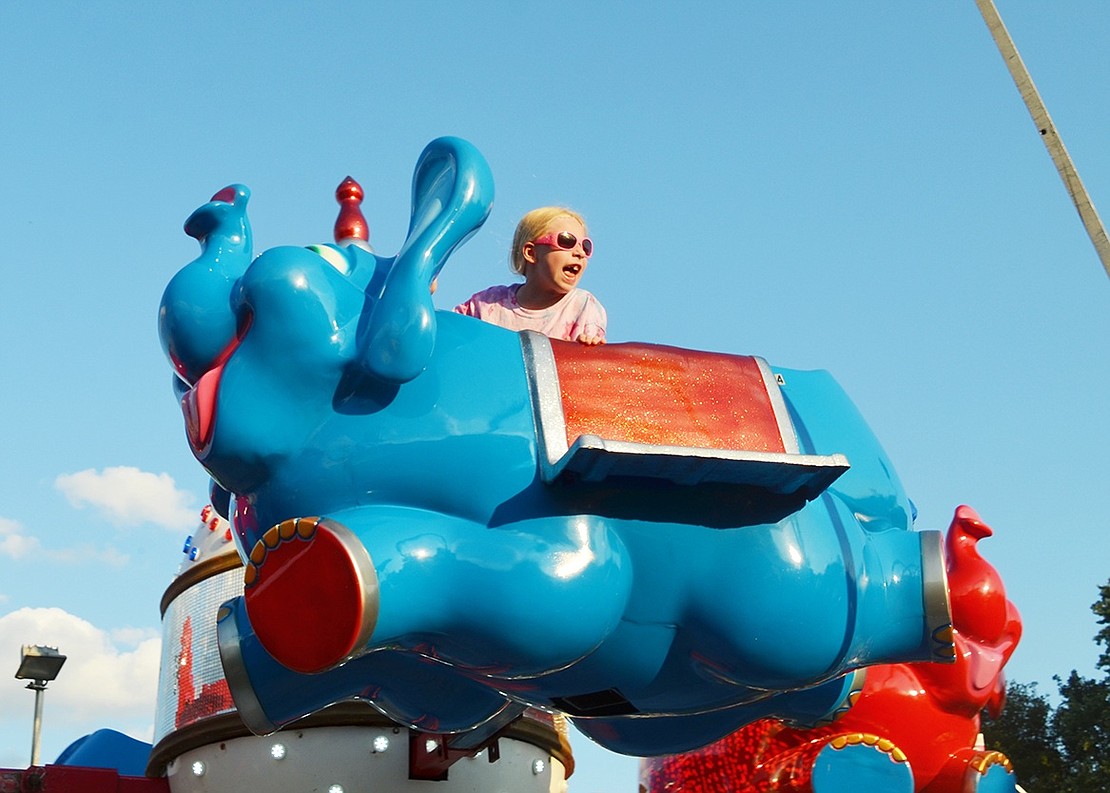 Who said elephants can’t fly? Seven-year-old Veronica Scullion of South Regent Street takes to the sky with a smile on her face and words to scream to her mother, who was watching below. 