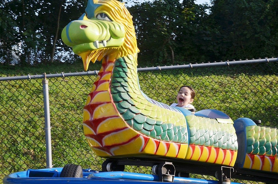 Port Chester resident Brianna Desouza screams her head off on the Dragon Wagon rollercoaster. The 6-year-old had a ton of fun at the St. John Bosco Parish (formerly Corpus Christi) Carnival on Wednesday, Aug. 16. The carnival continues through Saturday, Aug. 19 on the field behind Corpus Christi Church.