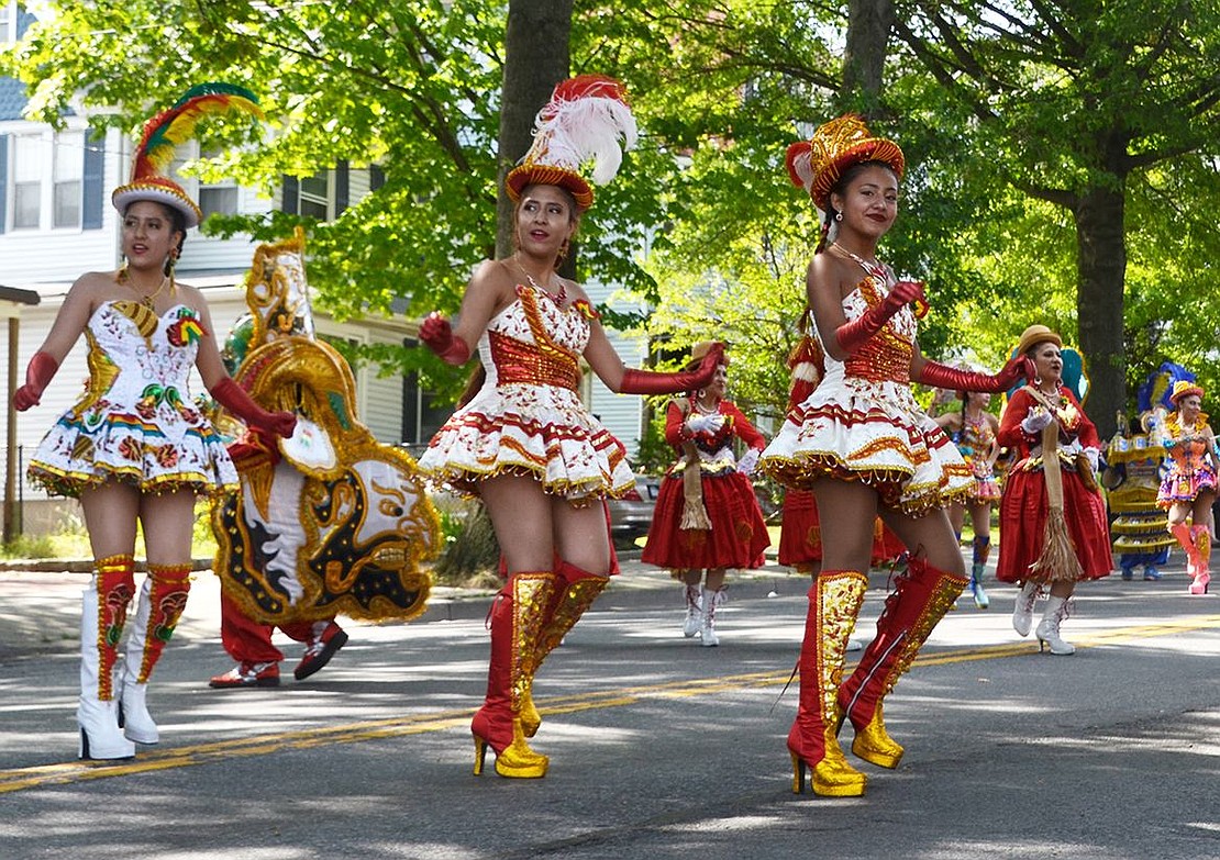 Women from Fraternidad Morenada Central U.S.A. don the colors of fire and light up the parade with their sultry steps. 