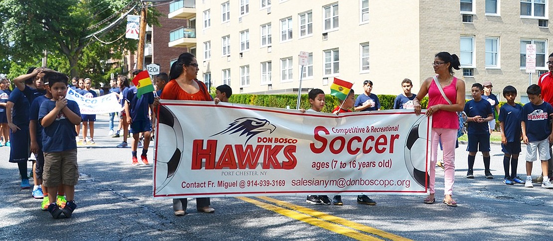 The Don Bosco Hawks soccer teams from Port Chester proudly embrace their heritage by marching in the parade. 