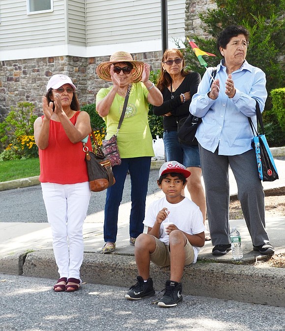 Most of the onlookers watched the festivities through their phone screen, but Maria Zurita, her grandson Gris Evans, 9, Yolanda Tellez, Lilliana Jerias and Dora Bernal, all from West William Street, enjoy them the old-fashioned way – by clapping and cheering as the dancers pass them by.  