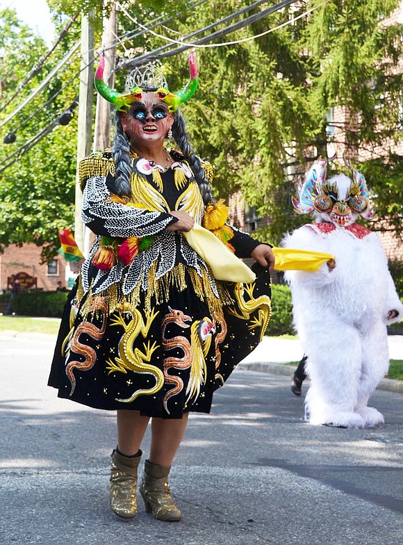 Dressed in a colorful costume adorned with lizards and snakes, Sonia Teoleria of Port Chester marches with the Fraternidad La Diablada Port Chester contingent.