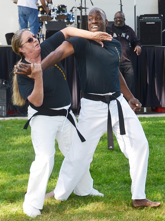 Arlene Cenner of Pleasantville and Russell Fulmore of White Plains, who began karate classes with Rico Dos Anjos at Don Bosco Center in Port Chester 39 and 41 years ago, respectively, demonstrate how karate can be used for self-defense. They are both 9th degree black belts. 