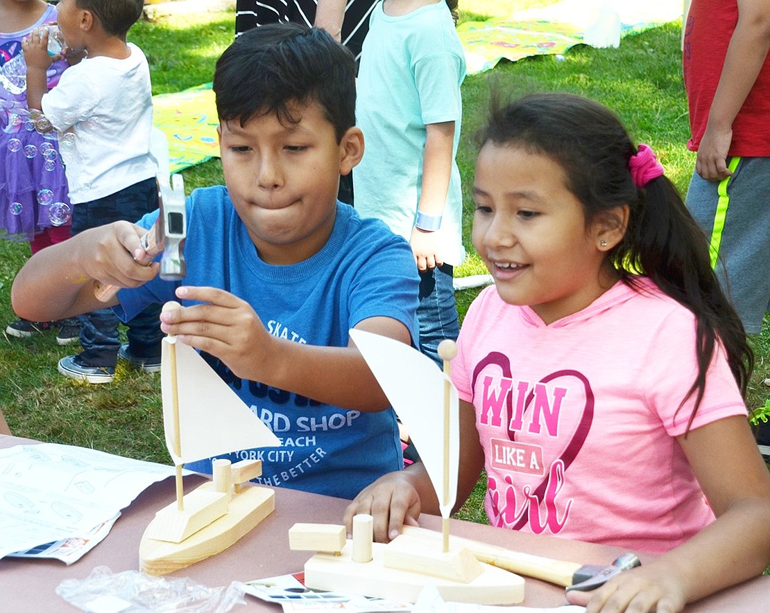 Brian Affon, 10, and his sister Katie, 8, of Nicola Place get a thrill out of building their own sailboats out of wood at one of the two popular craft tables set up by Home Depot.