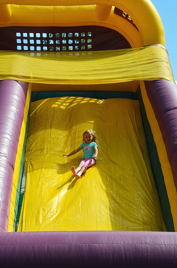 Harlow Halloran, 4, of Mamaroneck slips down the slide. Her mother, Cassandra Lovallo, grew up in Port Chester.