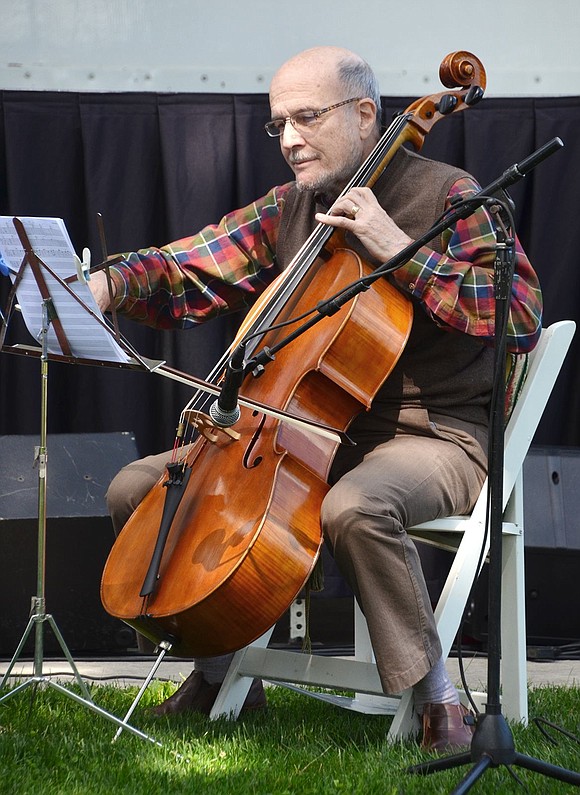 Dickie Danehouer of Greenwich plays with the Tre Amici Cellisti, one of the many musical groups entertaining those who came out for Port Chester Day. 