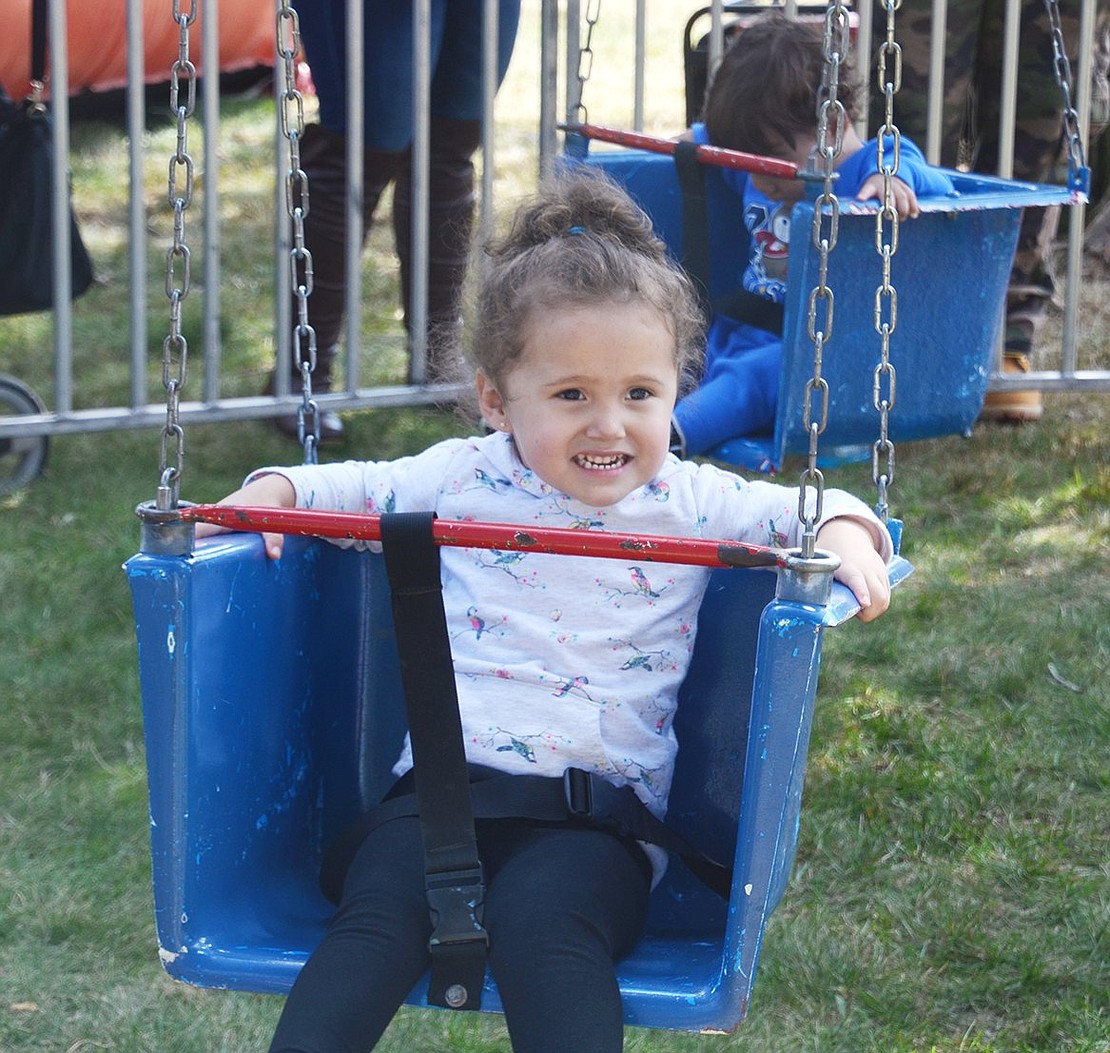 Three-year-old Analiyah Arteaga Acosta of Stamford, Conn. rides the swing. Her mother’s family lives on Grace Church Street in Port Chester.