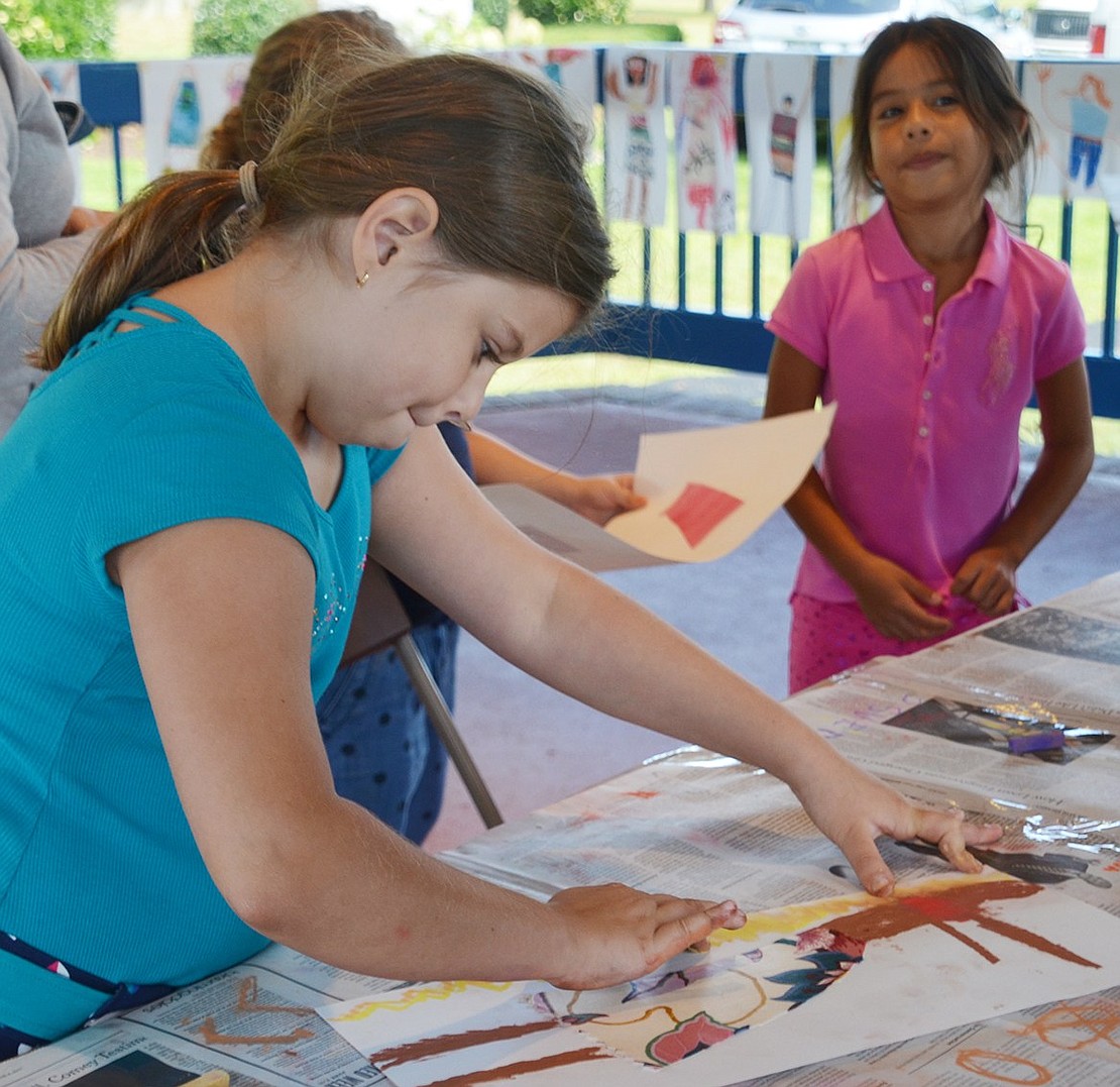 Eight-year-old Anastasia Wojdyla, a third grader at Kennedy Magnet School, completes her art project under the gazebo. The Nowodworski Foundation, which periodically runs free art workshops at the Port Chester-Rye Brook Public Library, kept the artistic children occupied at Port Chester Day on Saturday, Sept. 9 at Lyon Park.