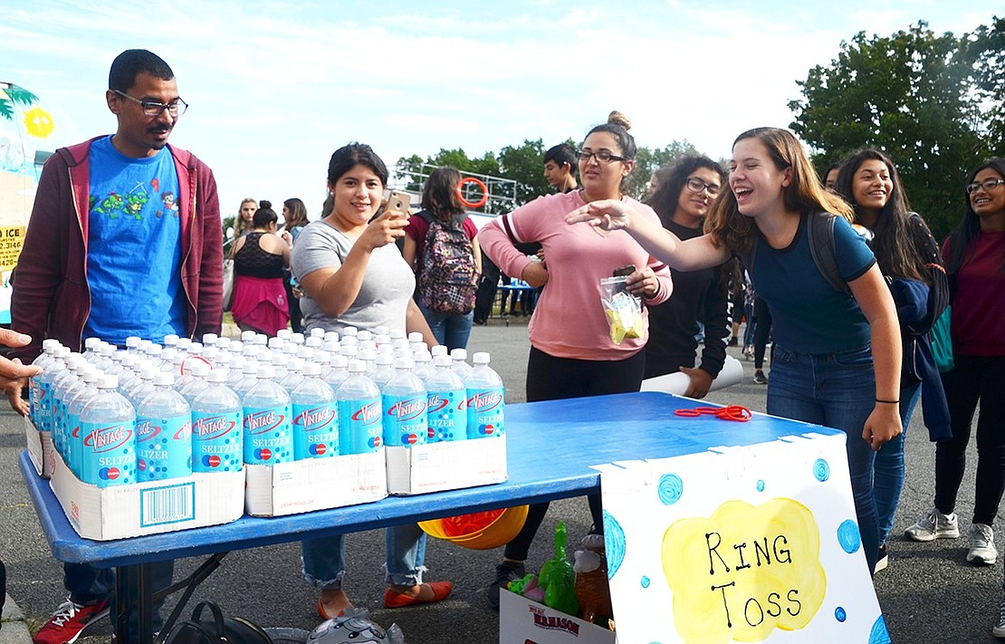 Lyndsay Rosenfeld’s aim was true – she looped one ring around a bottle, but didn’t manage to hit the right bottle to win a giant stuffed teddy bear. 