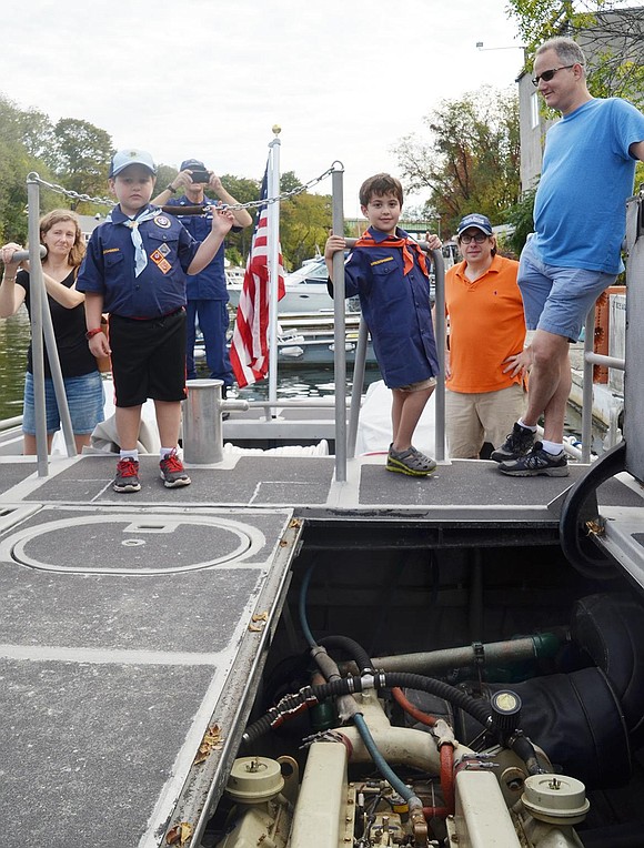 The Cub Scouts and parents check out one of the two ship engines. 