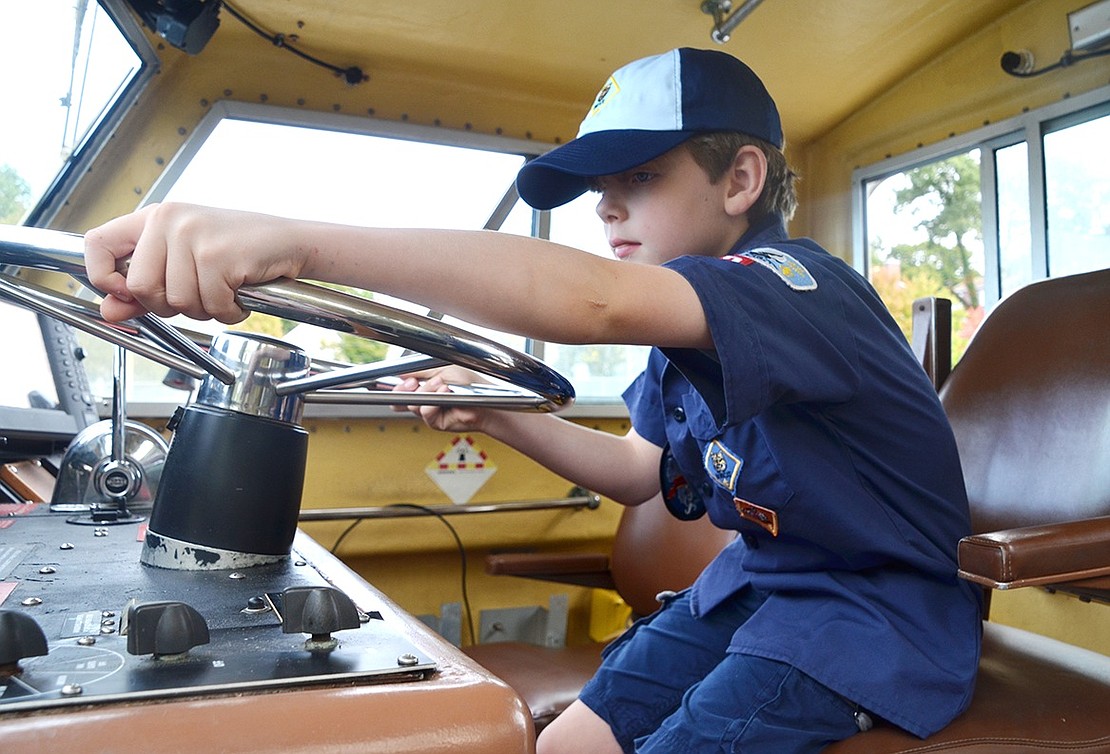 The early bird gets the worm, or in this case, the captain’s chair. Eight-year-old Will Boyd of Mohegan Lane was the first of the older kids in Pack 3 to make it onto the Coast Guard Auxiliary’s boat on Saturday, Oct. 7. The boat is docked in Port Chester behind Waterfront Place and the Rye Brook Cub Scouts took full advantage of this learning opportunity. 