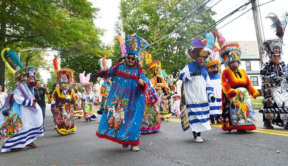 Colorful characters from Los Chinelos de San Pedro in Queens join in the fun. 