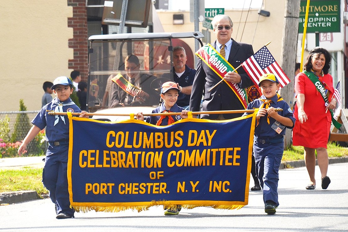 The sky was gray, but rain didn’t hinder the festivities this time. Grand Marshall Steven J. Giamundo leads the Columbus Day parade with Cub Scouts carrying the Columbus Day Celebration Committee banner on the event’s rain date, Sunday, Oct. 15. 