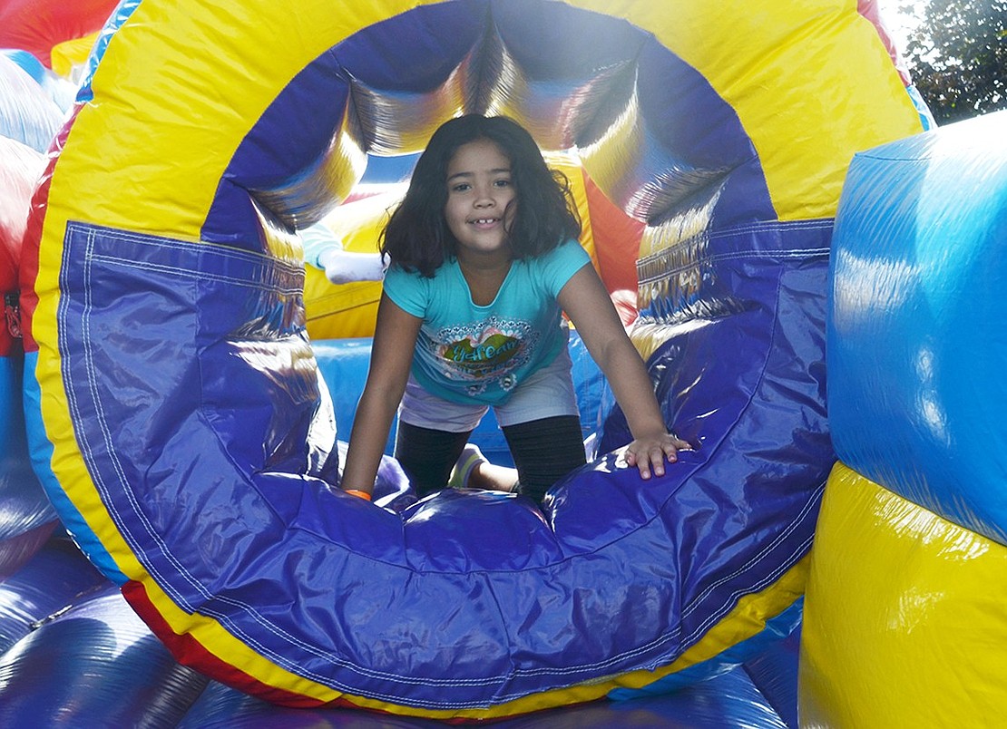 Park Avenue School third grader Amelia Jimenez runs through the inflatable obstacle course for a second time. 