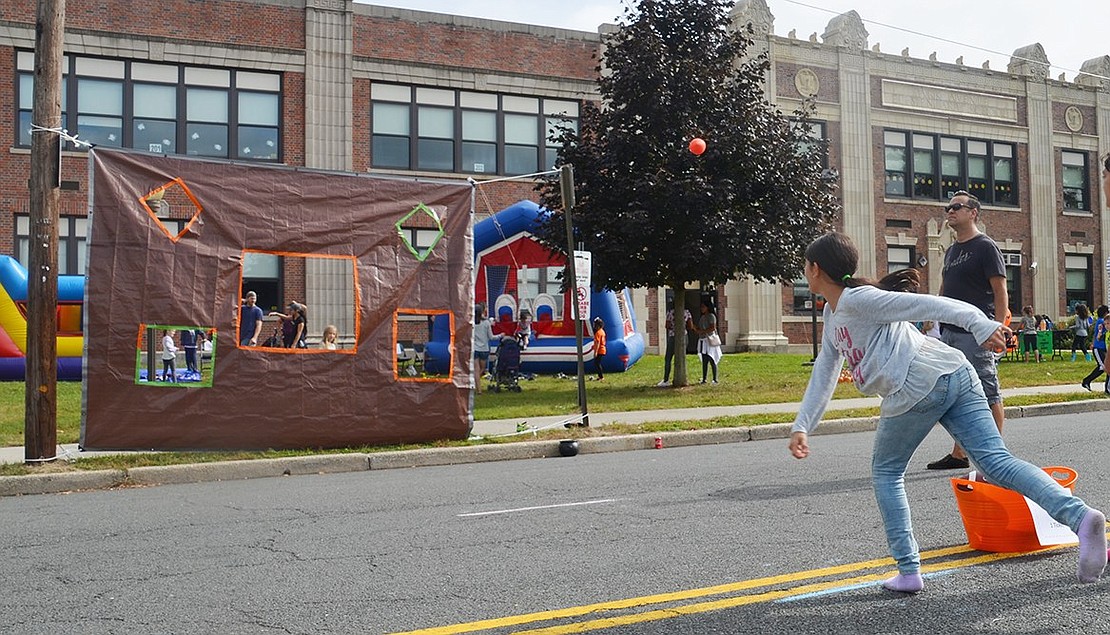 Fiorella Deus tests her aim and skill as she hurls a ball towards a target. The 10-year-old Park Avenue School student missed by inches. 