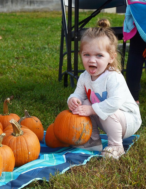 The pumpkin might have been a little too heavy for 2-year-old Gabrielle Giordano. The Monroe Place resident stuck out her tongue and squinted every time she lifted the orange gourd. 