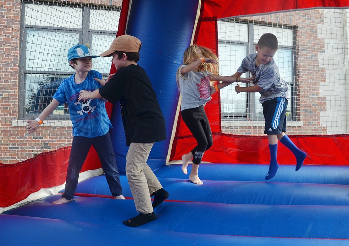 Many kids bounce away their morning energy in one of the event’s two bounce houses.  