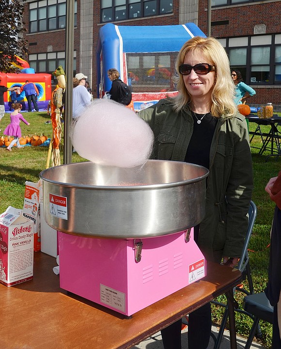 Susan Ann Cosgrove prepares cotton candy larger than her head. 