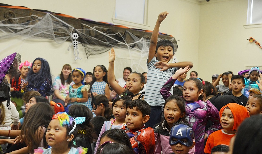 Enthusiastic kids put their hands in the air and shout whenever the audience is asked to participate. 