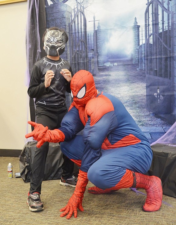 Spiderman (Mark Parham of the library) poses with Black Panther (Sergio Morales, 8, of Port Chester). 