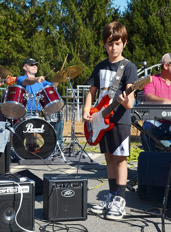 Juan Anton is center stage during his musical debut. The Ridge Street School fourth grader has only been playing guitar for a year and loves to cover “Guns N Roses.”