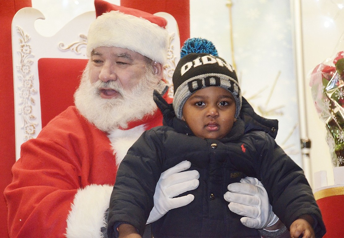 Port Chester 3-year-old Croix McCurdy looks a little skeptical of Santa Claus. 