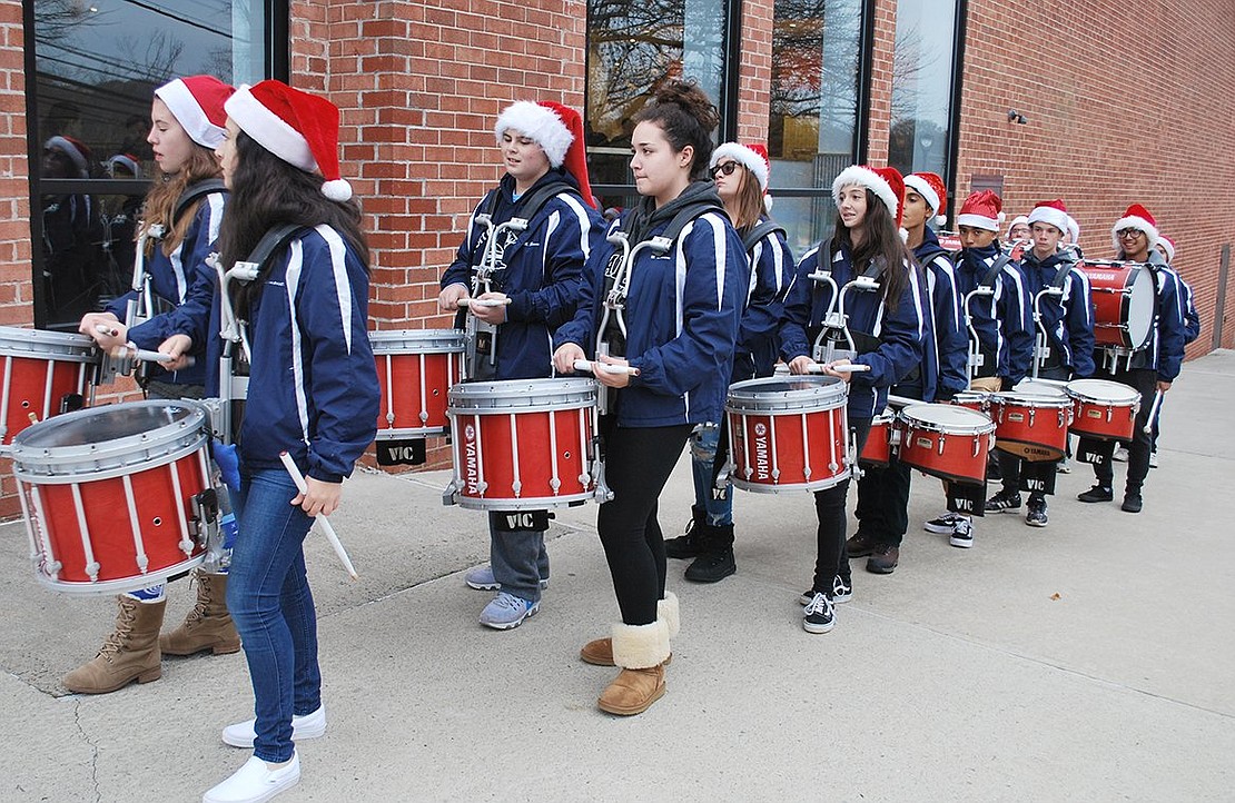 The Pride of Port Chester drumline waits around the corner to make their grand entrance along the sidewalks of Rye Ridge Shopping Center. 