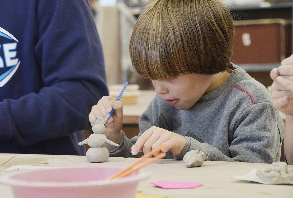 Six-year-old Thornwood resident Leo DiNota practices extreme focus while detailing his snowman ornament in a Clay Art Center classroom at 40 Beech St. DiNota came to the Kids Ornament Making Clay Class with his school friend and parents on Saturday, Dec. 2. Another class will take place at 1:30 and 3:30 p.m. on Saturday, Dec. 9. 