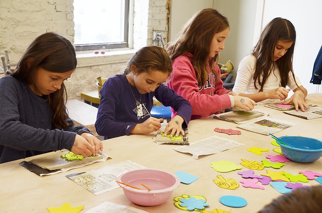 Cecilia Hoogstra (left), Laeticia Clauss, Thea Fortin and Elina Francis use stencils to sketch and carve holiday ornaments. The four fifth-grade friends came to the workshop together from Rye. DSC_4865 Clay Center Ornament Class .psd The 11 participants work hard to bring festive decorations home. Each child made multiple clay ornaments, which will be ready to pick up before the holidays begin. 