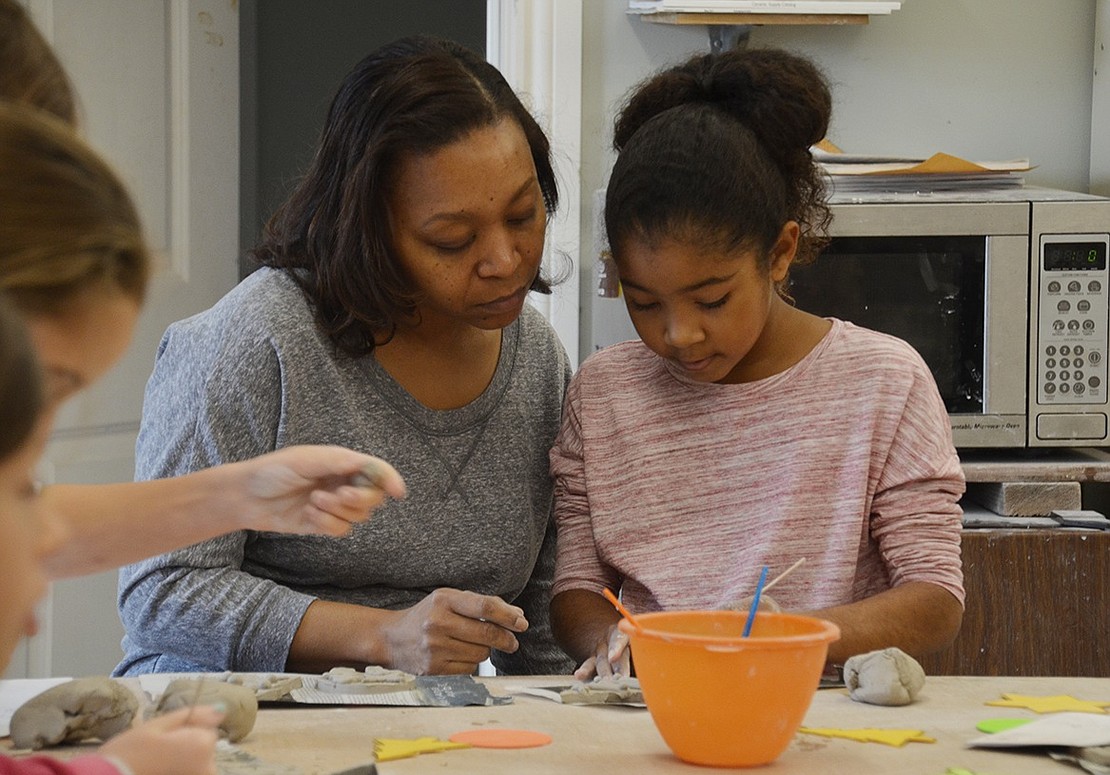 New Rochelle resident Morayada Rosado and 6-year-old Nyah Rosado decorate clay Christmas trees during their mommy-daughter day together at the ornament making class. 