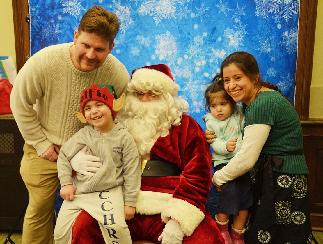 Port Chester residents Estrella and Bruce Marziani bring their children Matteo, a 4-year-old and Caterina, who is about to be 2 years old, for a family photo with Santa Claus. The Marziani family always goesto Port Chester-Rye Brook Public Library holiday programs throughout the year. 