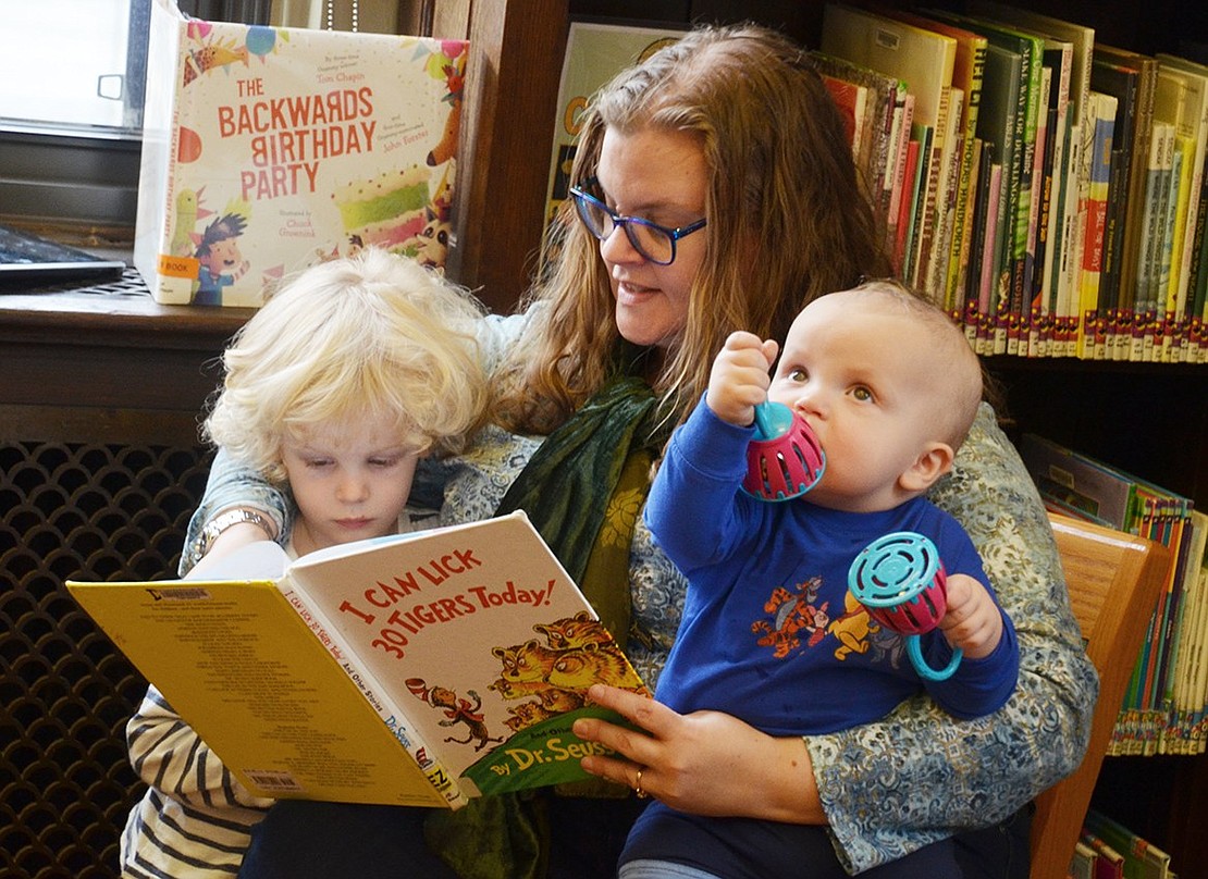They are in the library! Summit Ave resident Lesley Zlabinger reads a Dr. Seuss book to her 3-year-old son, Jack, while her other son, 11-month-old Huey, is distracted by some toys.  
