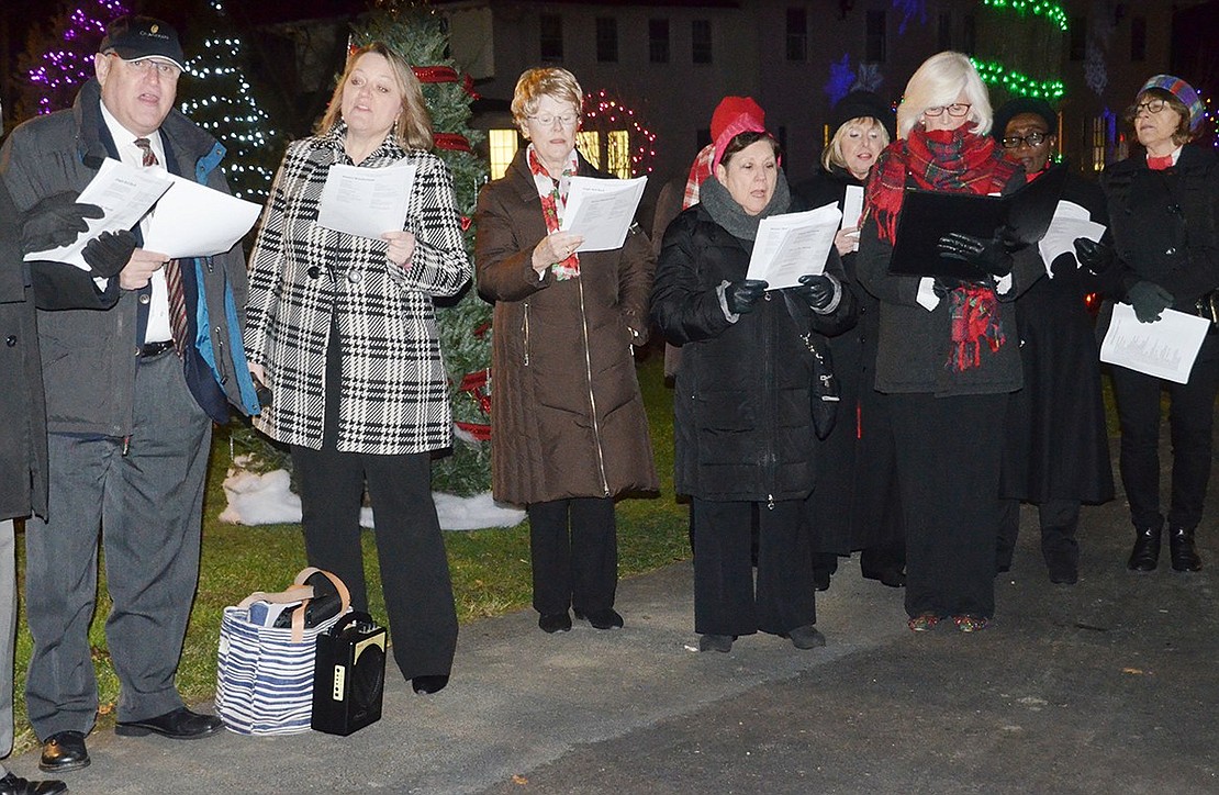 Members of the Village Singers of Westchester sing “Dreidel Song” before the tree and menorah lighting ceremony. The singers sang a multitude of holiday songs, including “Jingle Bells” and “Hanukkah, Oh Hanukkah.”